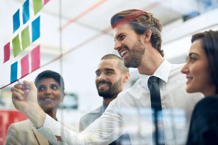 Their plans for success is already succeeding. Cropped shot of a group of colleagues working at the...