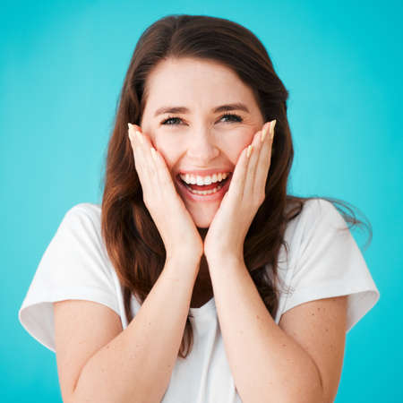 You shouldnt have. Studio portrait of an attractive young woman looking surprised against a blue...