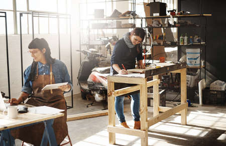 Creating masterpieces from wood. Cropped shot of two attractive young creative female artisans...