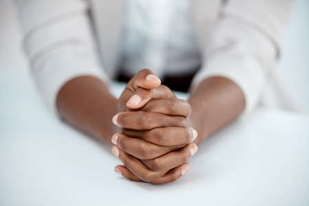 If you havent found it yet, keep looking. Shot of a businesswoman resting her hands on the table.の写真素材