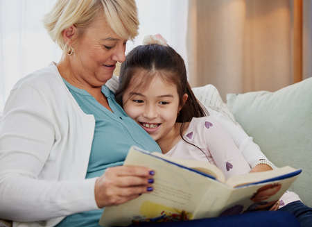 What happened next. Shot of a woman reading to her granddaughter at home.
