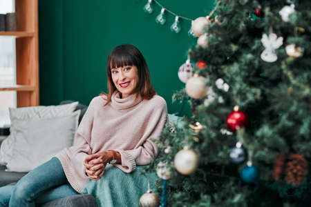 The perfect gift is me. Portrait o a young an attractive woman relaxing on the sofa next to a...