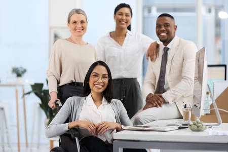 This teams going to the top. Cropped portrait of a group of diverse businesspeople smiling while gathered in their office.の写真素材