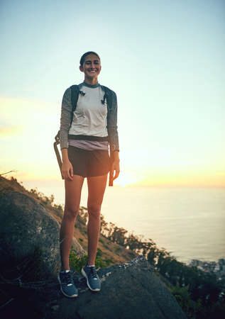 It thrills me to be out in search of adventure. Portrait of a young woman out on a hike through the mountains.の写真素材