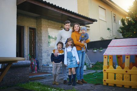 Family is everything. Shot of a family of five standing in their backyard.の写真素材