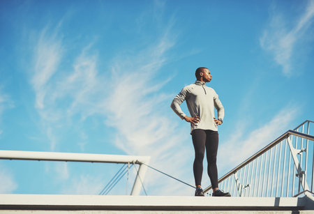 Working out is a reward, not a punishment. Shot of a young sporty man standing outside.の写真素材