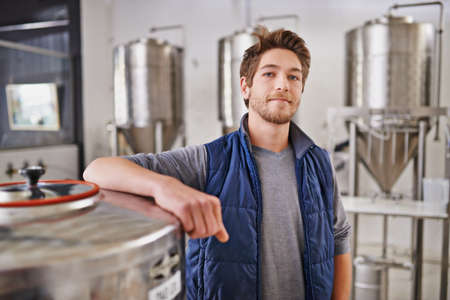The master brewer himself. Portrait of a man working in a microbrewery.の写真素材