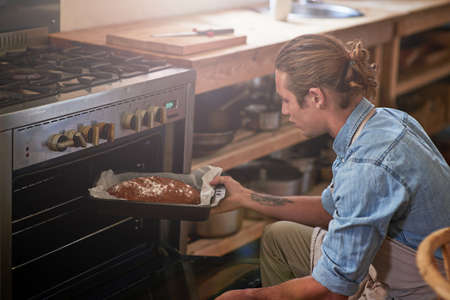 Life is what you bake it. Cropped shot of a man baking.の写真素材