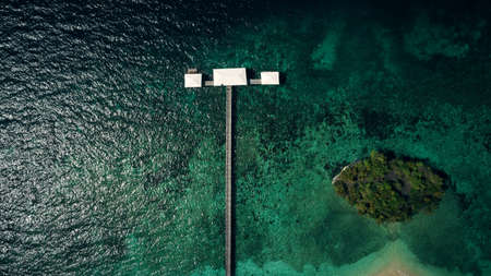 A breathtaking view of the big blue. High angle shot of a pier along the island coasts of Indonesia.の写真素材