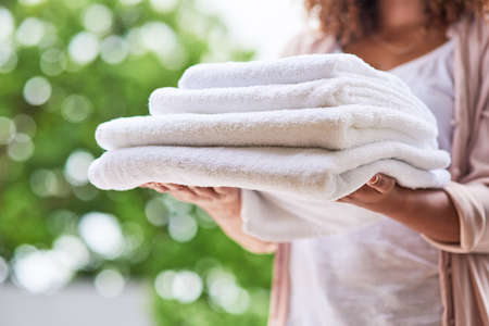 Another successful laundry day. Shot of an unrecognizable woman doing laundry at home.の写真素材