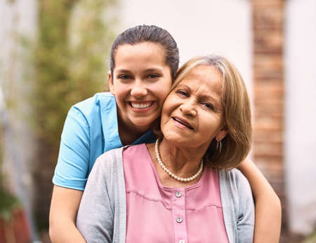 Shes like a mother to me. Portrait of a senior patient outside with her caregiver.