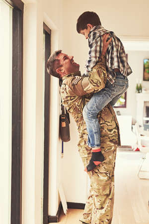 Look how big youve gotten. Shot of a little boy welcoming his father home from the army.
