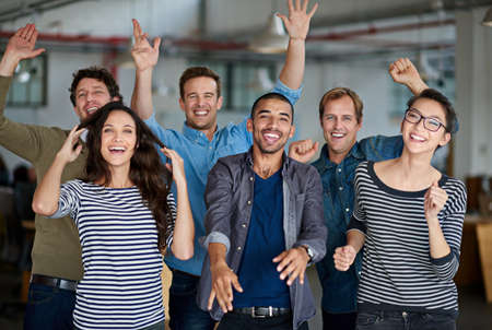 Now thats what I call team spirit. Joyous group of office staff jumping around and having fun...