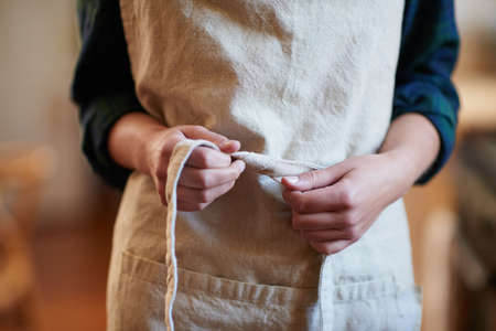 Getting prepped. A young woman wearing an apron.の写真素材