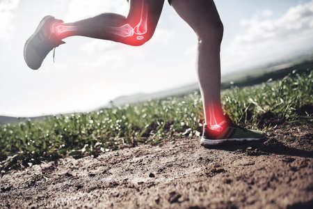 His joints are taking a beating. Shot of an unrecognizable man running with injuries highlighted by...