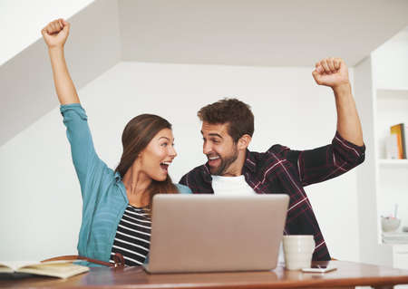 Our startup dreams are coming true. Shot of a couple of happy entrepreneurs celebrating an...