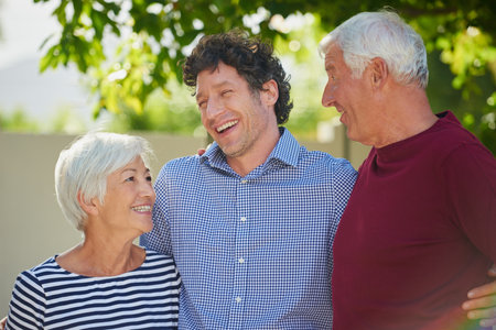 They couldnt be more proud. Cropped shot of a senior couple standing outside with their son.