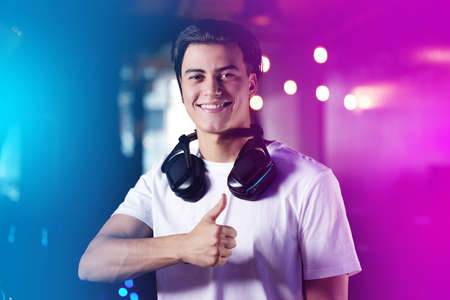 For the good of the game. Shot of a young man showing thumbs up while playing computer games.