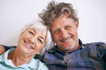 Still very much in love. Portrait of an affectionate senior couple sitting together.