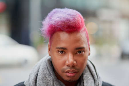 I like my hairstyle to stand out from the crowd. Portrait of a young man with a funky hairstyle...