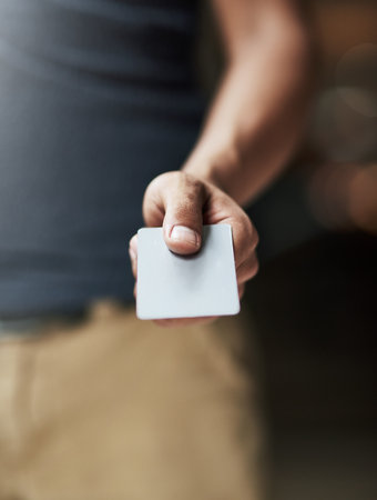 Payment made easy. Shot of a man holding out a credit card.の写真素材