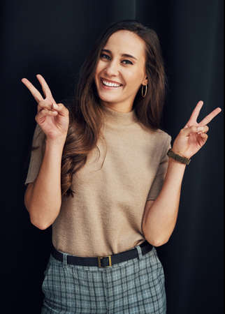 Give this world good energy. Cropped portrait of an attractive young woman standing alone against a...