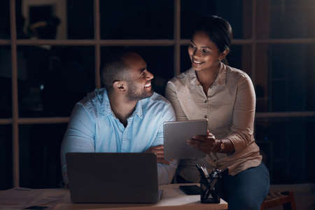 Thank you for thinking about me. Shot of a young couple using a digital tablet together at night.