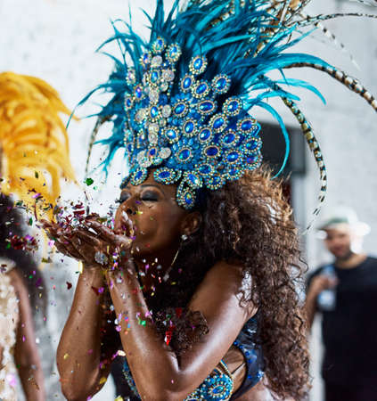 All this glitter is gold. Cropped shot of a beautiful samba dancer performing in a carnival with her band.の写真素材