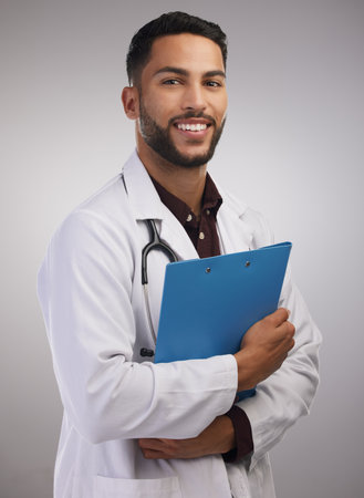 I was always meant to be a doctor. Shot of a handsome young doctor standing alone in the studio and...