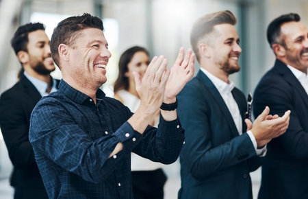 Now thats a standing ovation. Cropped shot of a group of businesspeople applauding during a seminar in the conference room.の写真素材