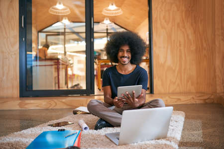 With wireless tools, I can work just about anywhere. Portrait of a young designer working on the...
