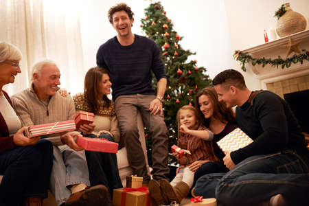 Family time is the greatest gift of all. Shot of a multi-generational family exchanging gifts at...