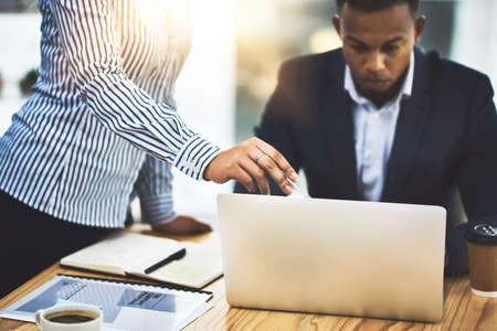 Searching online for some new ideas. Shot of two businesspeople working together on a laptop in an...