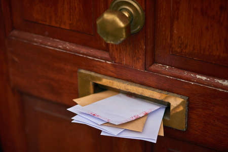 Youve got mail. Cropped shot of letters in a letter box.の写真素材