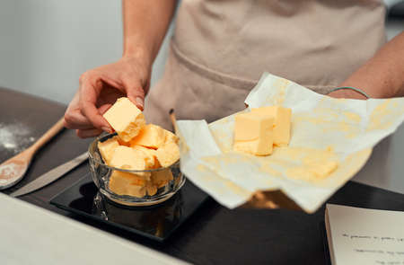 Theres no such thing as too much butter. Cropped shot of an unrecognizable woman adding blocks of...