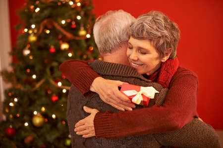 The gift of giving. A cropped shot of a loving senior couple exchanging gifts on Christmas.
