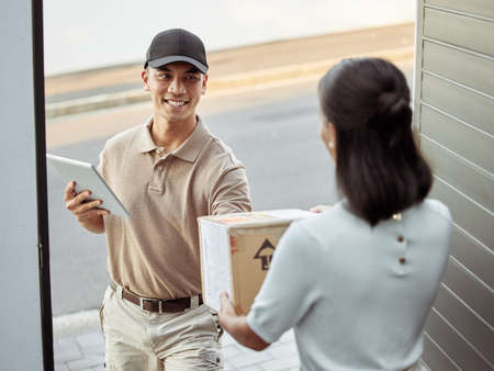 That was a fast delivery. Shot of a young woman receiving an order.の写真素材