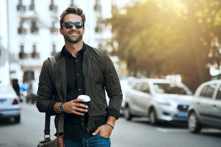 That urban feeling. Cropped shot of a handsome young man traveling through the city.の写真素材