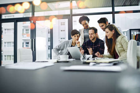 So this is the plan.... Cropped shot of a group of businesspeople working together on a laptop in a...