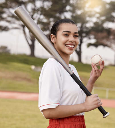 Ready to lose. Shot of an attractive young woman standing alone outside and posing with a baseball...