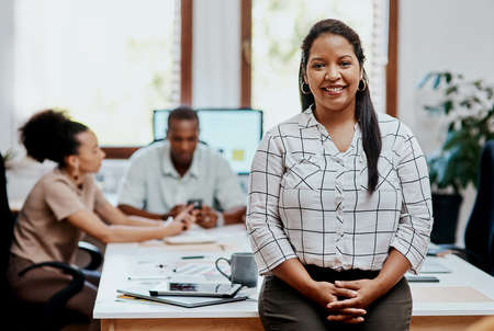 What an awesome team working behind me. Portrait of a confident young businesswoman with her team...