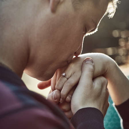 Give me your hand and Ill never let go. Shot of a young man affectionately kissing his girlfriends...