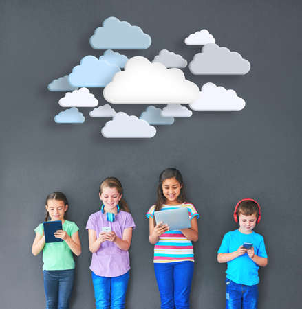 Kids keeping connected. Studio shot of kids using wireless technology with clouds above them against...