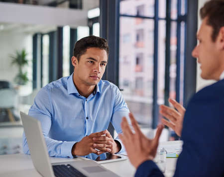 Focused on getting some serious business done. Shot of two businessmen having a meeting in an...