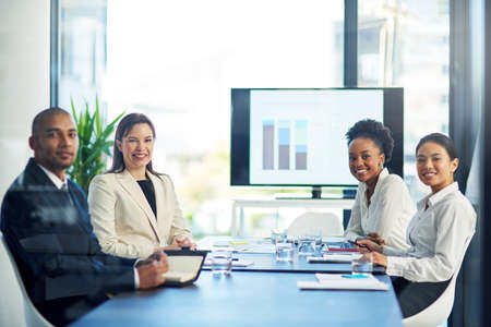 We know that hard work pays off in the end. Portrait of a group of businesspeople having a boardroom...
