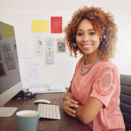 Todays forecast 100 chance of winning. Shot of a call centre agent sitting behind her computer.
