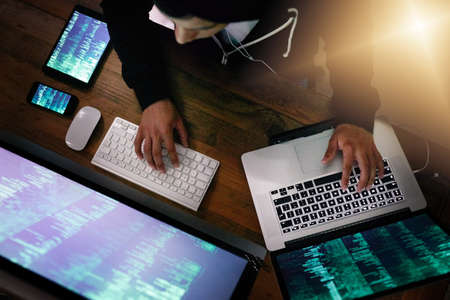 He knows how to exploit weaknesses in every cyber system. High angle shot of a hacker cracking a...