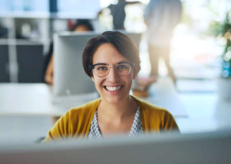 Im passionate about business. Portrait of a smiling young businesswoman working in a modern office.の写真素材