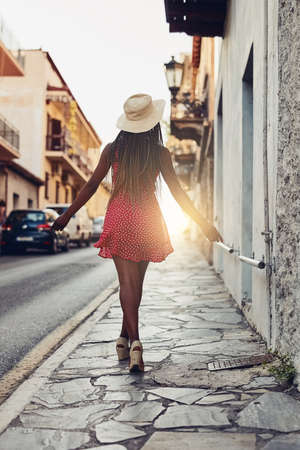 I love to see new places and experience the beauty. Shot of a beautiful young woman spending her day out exploring a foreign city.の写真素材