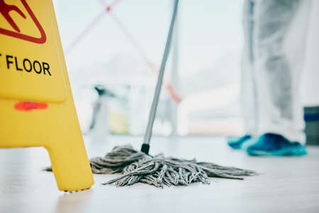 As clean as floors should be. Shot of a healthcare worker a wearing hazmat suit and sanitising a...